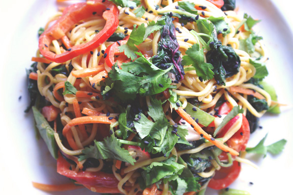 rainbow noodle salad with amaranth leaves and spicy peanut dressing.